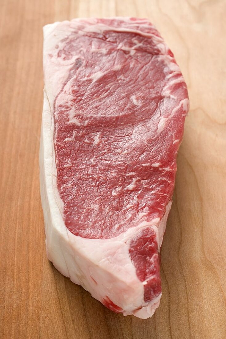 Beef steak on wooden background
