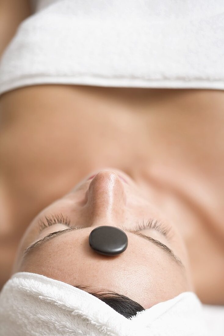 Woman having LaStone Therapy (healing therapy using stones)