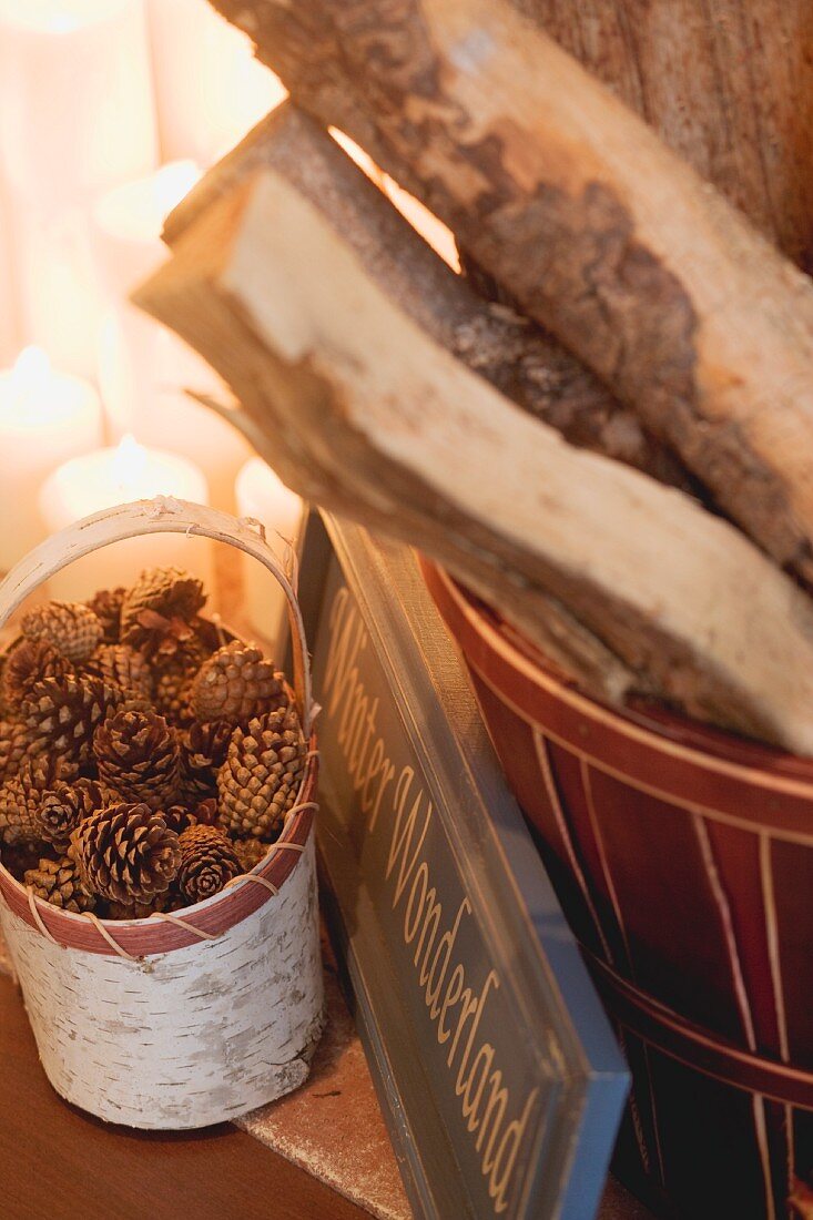 Logs in basket, candles and cones