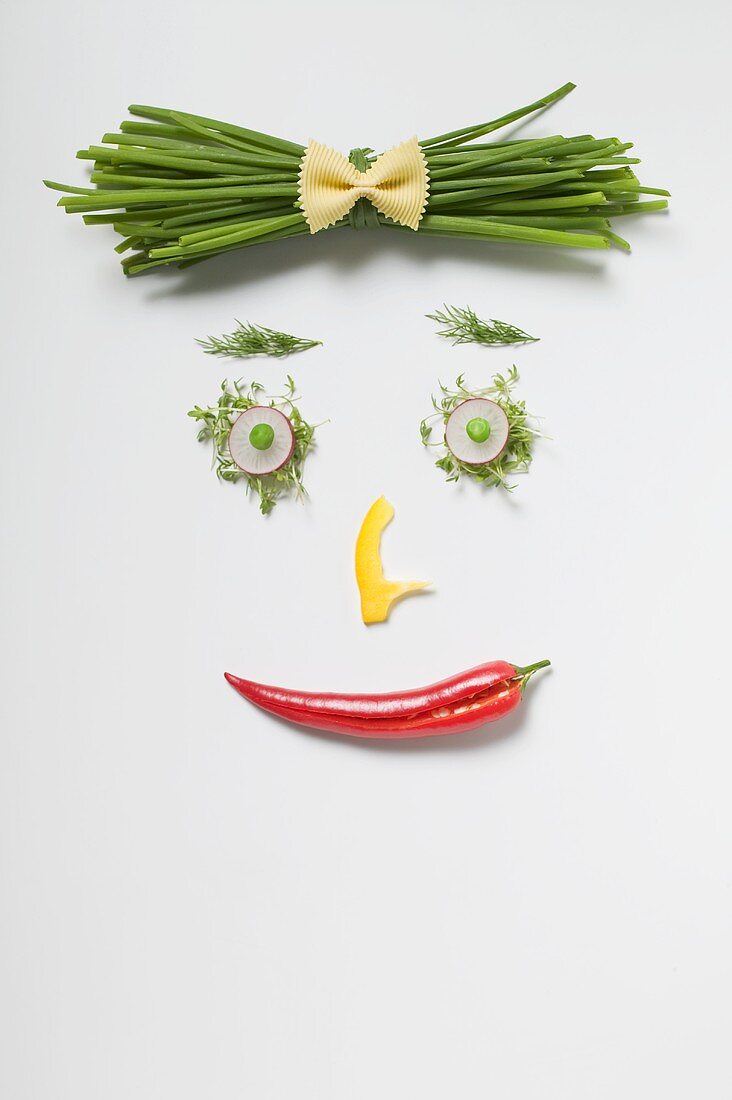 Woman's face made from vegetables, herbs & pasta bow tie