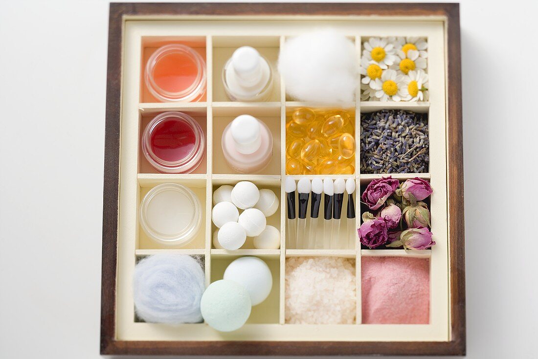 A selection of beauty products and flowers in type case
