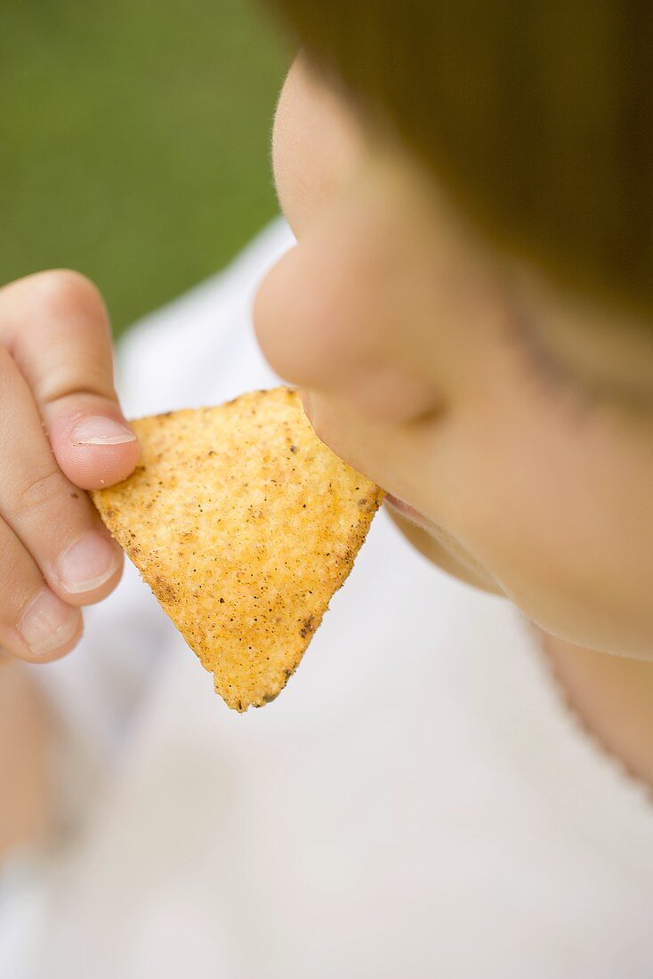 Child eating tortilla chip