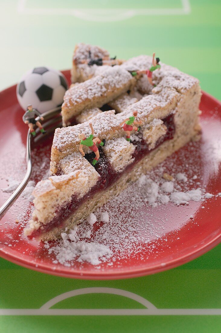 Piece of Linzer torte with football figures and football
