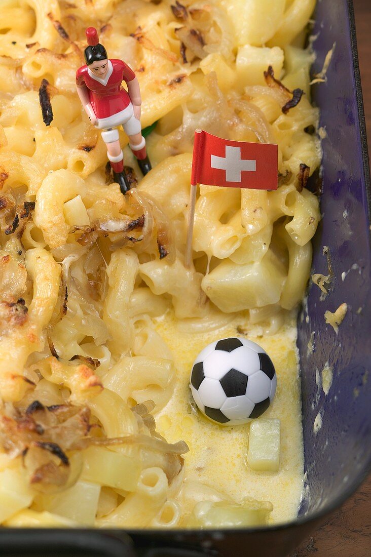 Cheese & onion pasta bake, football figure, football, flag (detail)