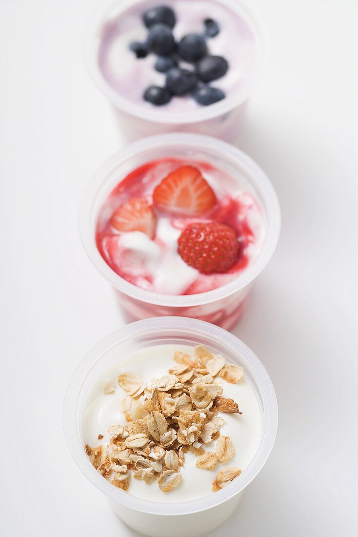 Three yoghurts with berries and with cereal