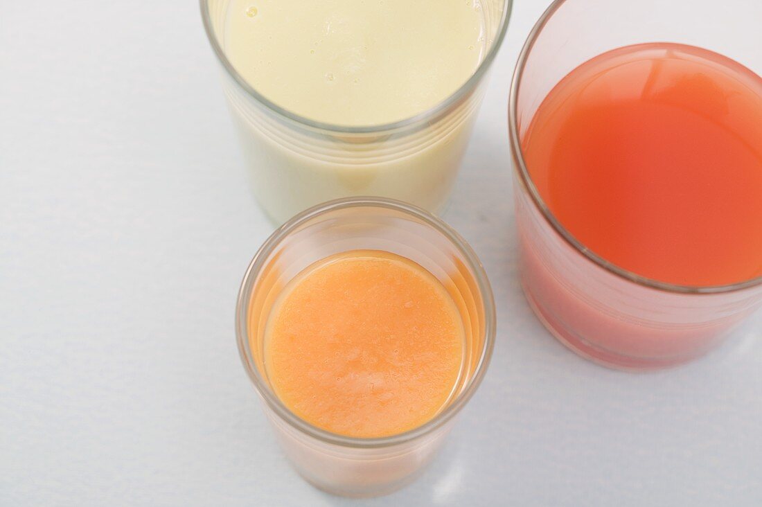 Three different juices in glasses (overhead view)