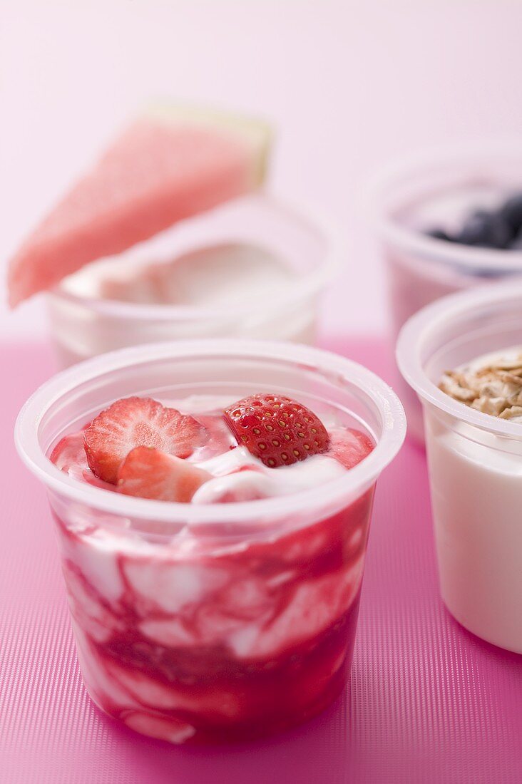 Assorted yoghurts with berries, melon and cereal
