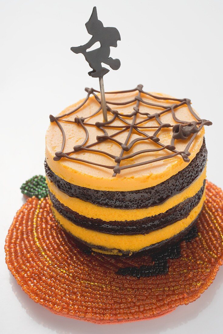 Pumpkin chocolate cake with witch for Halloween