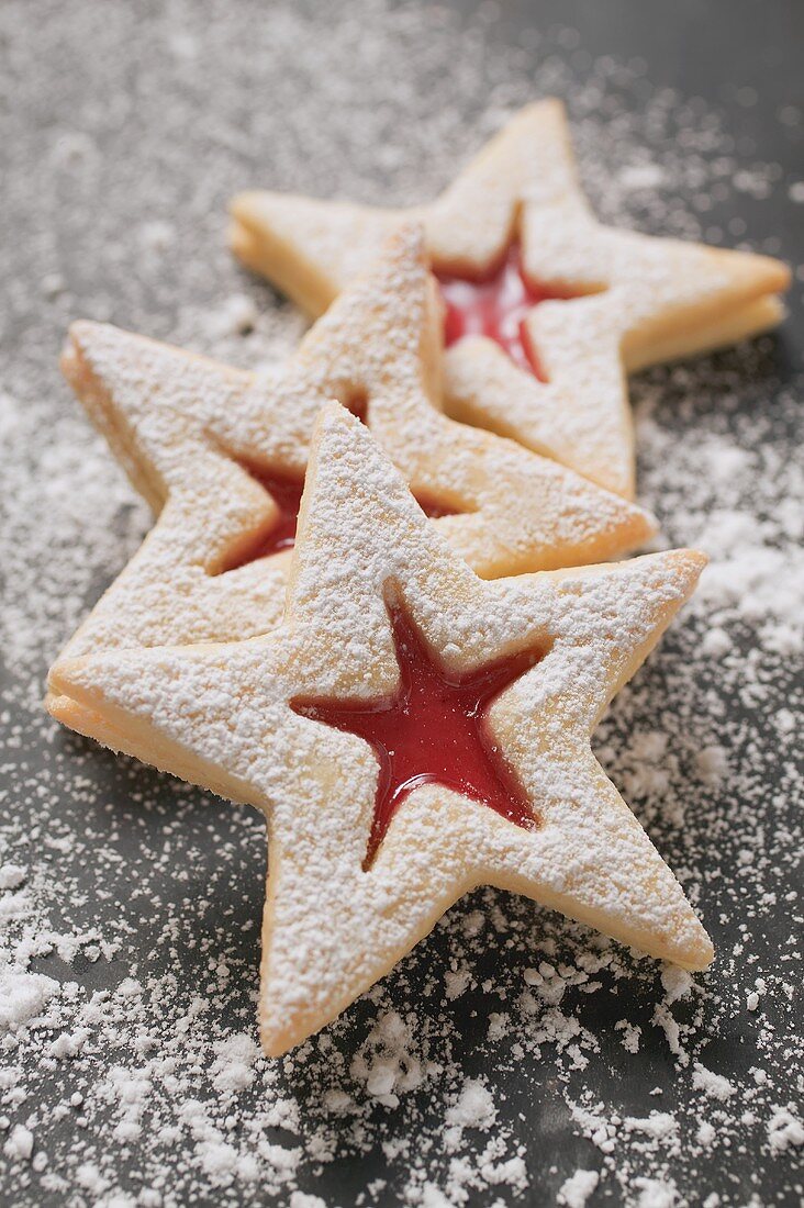 Three jam biscuits with icing sugar