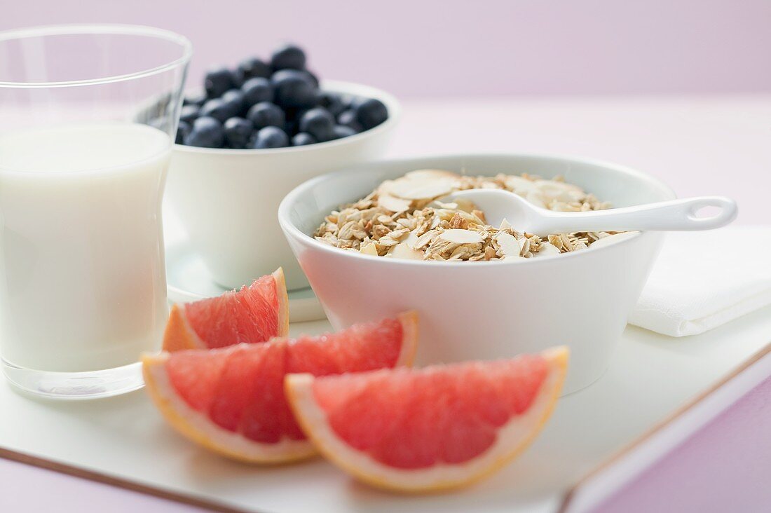 Muesli ingredients: cereal, yoghurt, blueberries, grapefruit