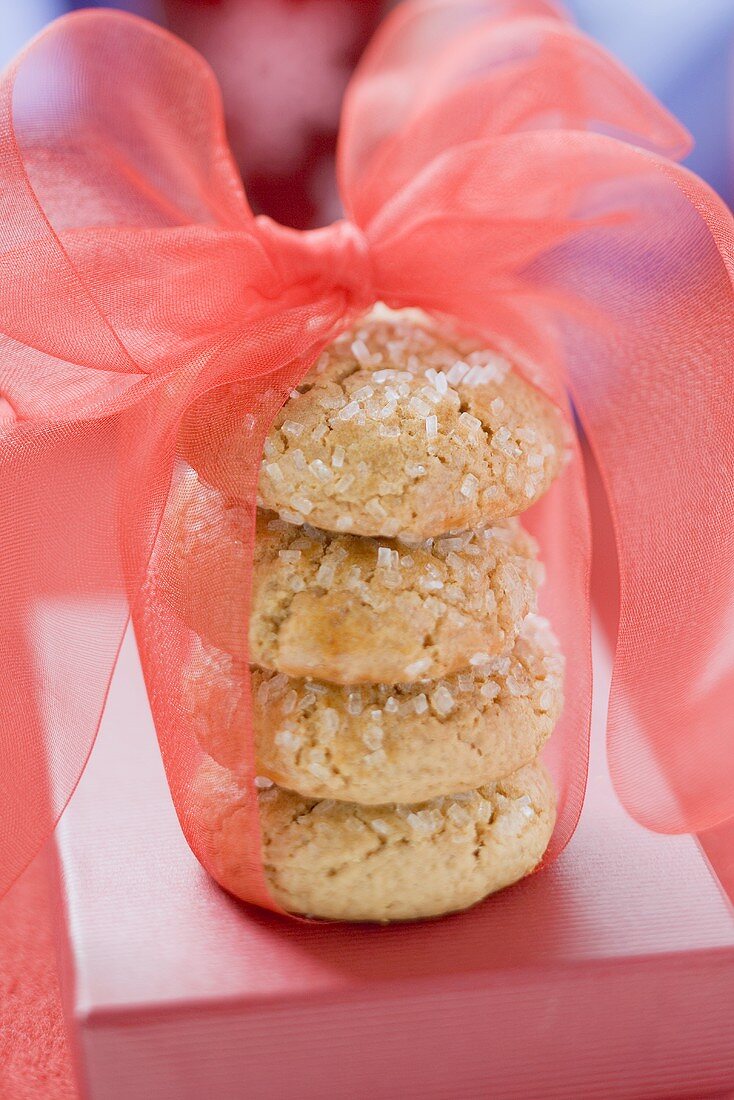 Four sugared biscuits, stacked, with red bow