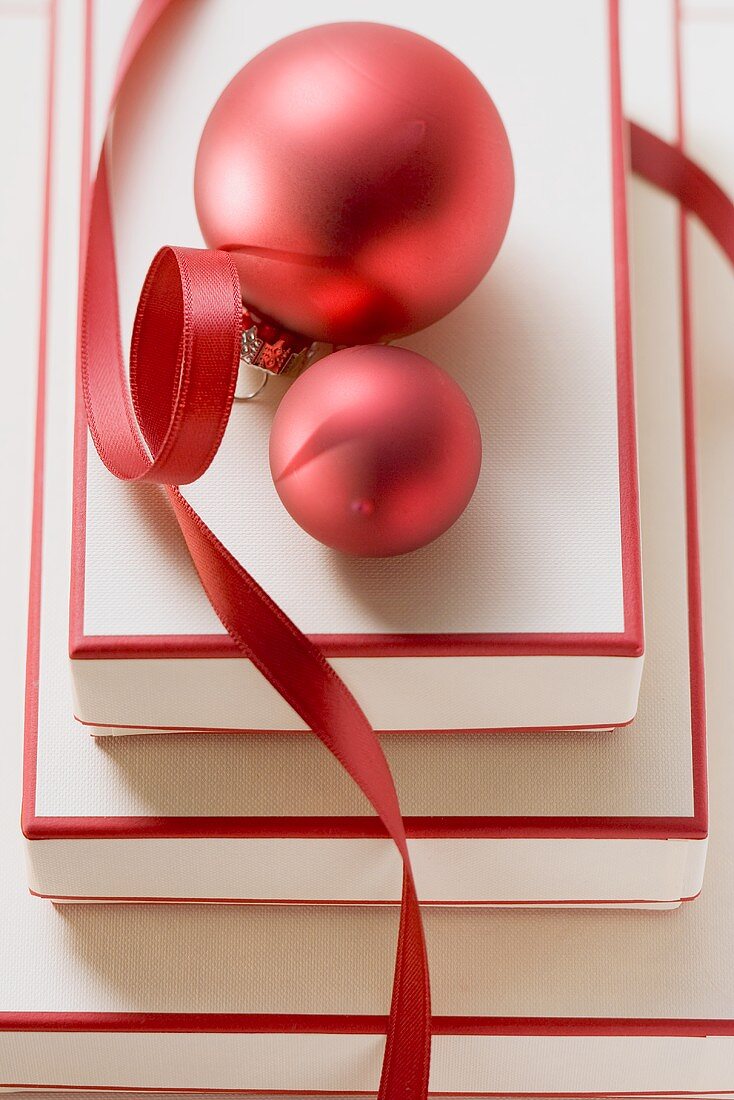 Red and white boxes, red Christmas baubles and ribbon