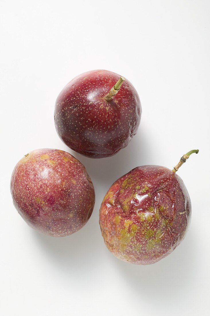 Three purple passion fruits