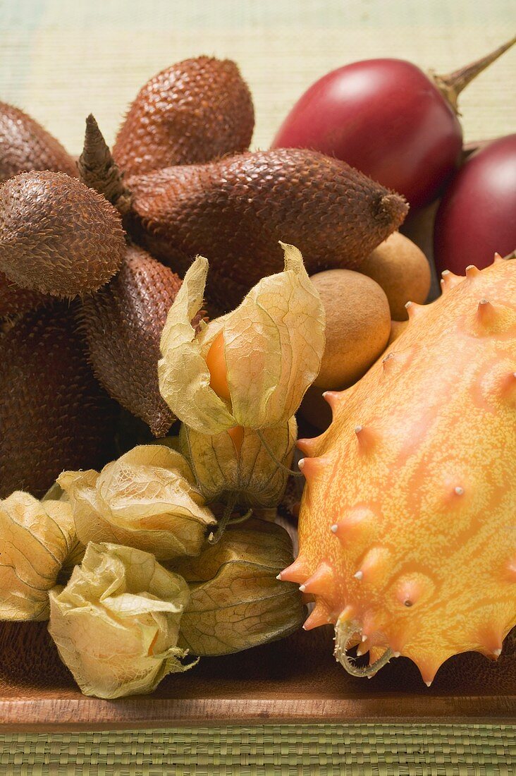 Assorted exotic fruits in wooden bowl