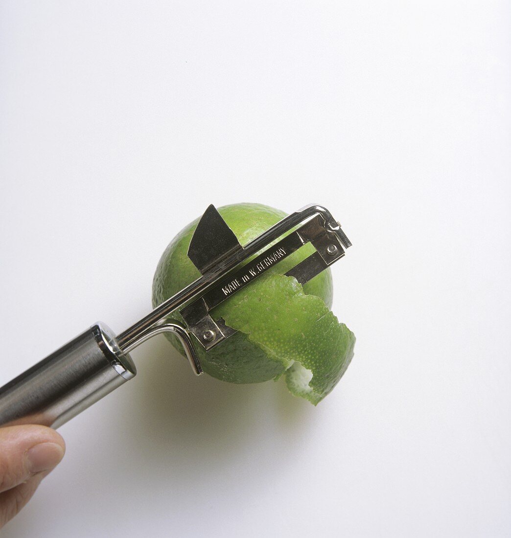 Peeling lime with vegetable peeler