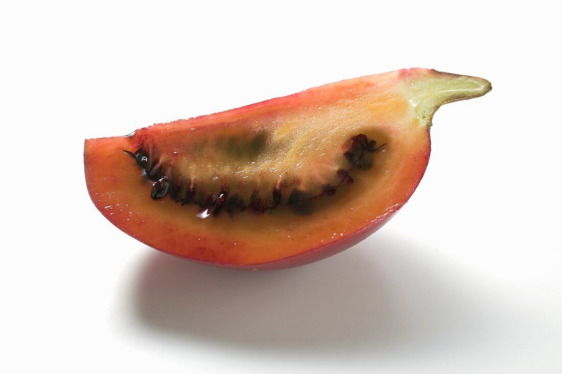 A wedge of tamarillo