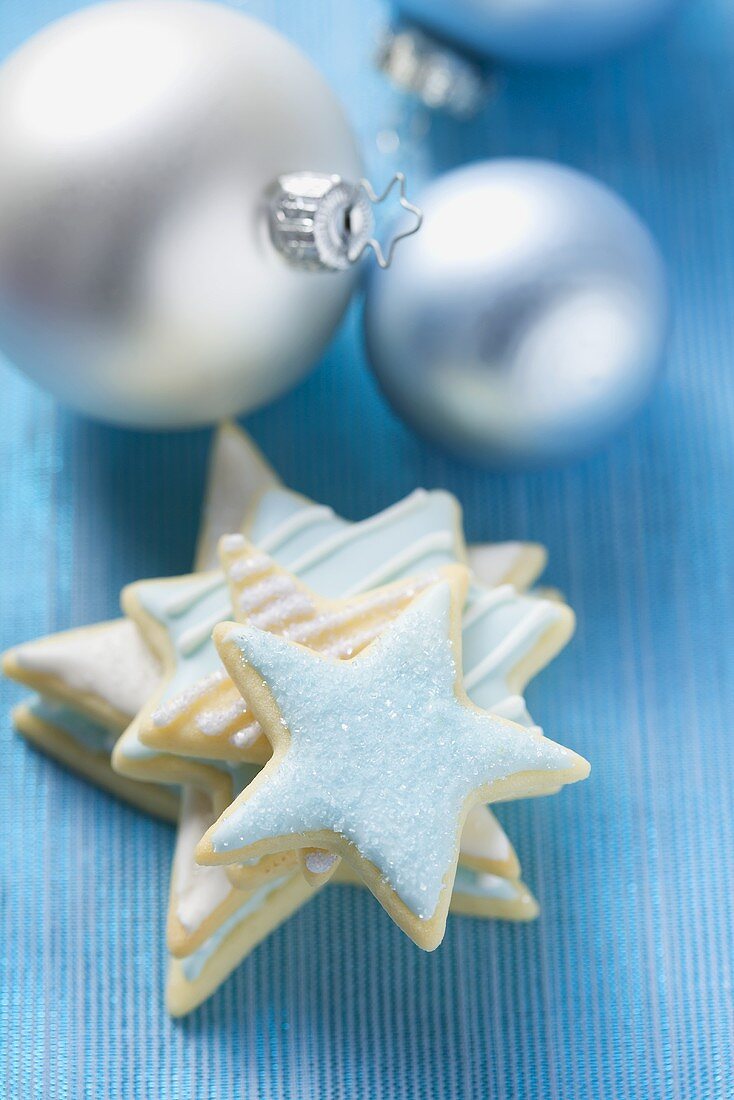 Iced star biscuits and silver Christmas tree baubles