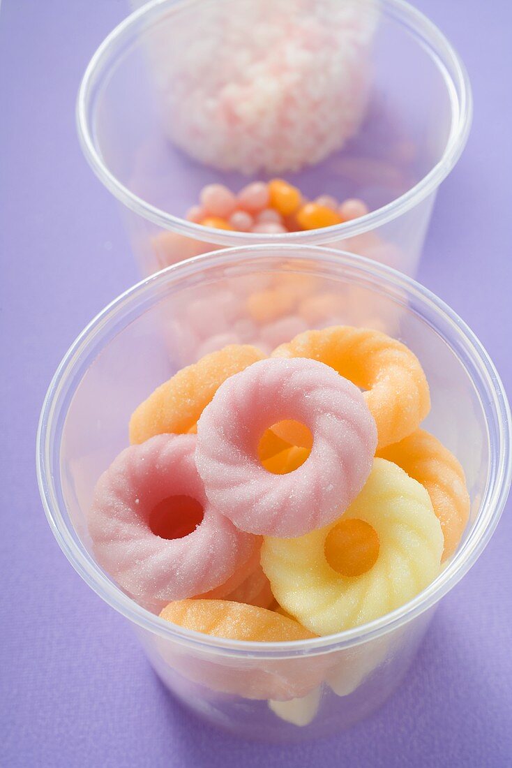 Sugar rings and other sweets in plastic tubs