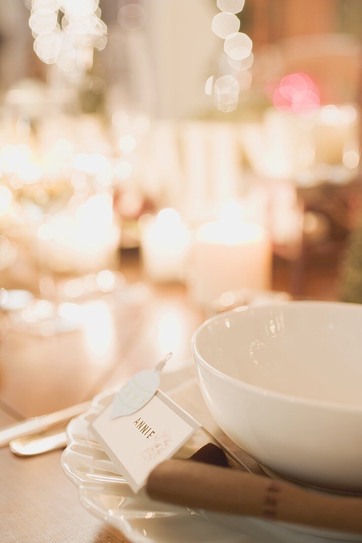Christmas place-setting with place card by candlelight