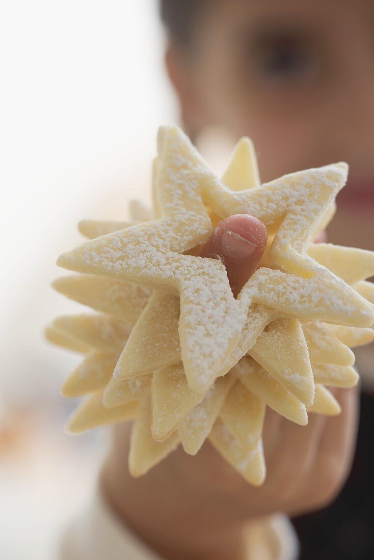 Girl with star biscuits on her finger