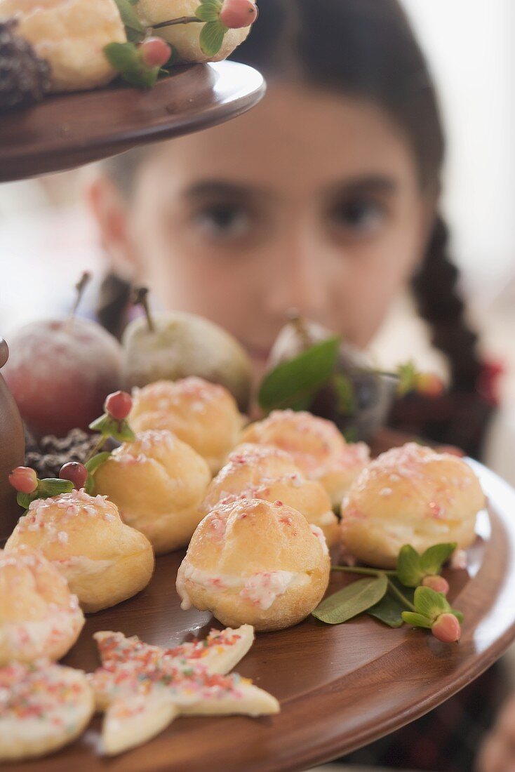 Christmas baking on tiered stand, girl in background