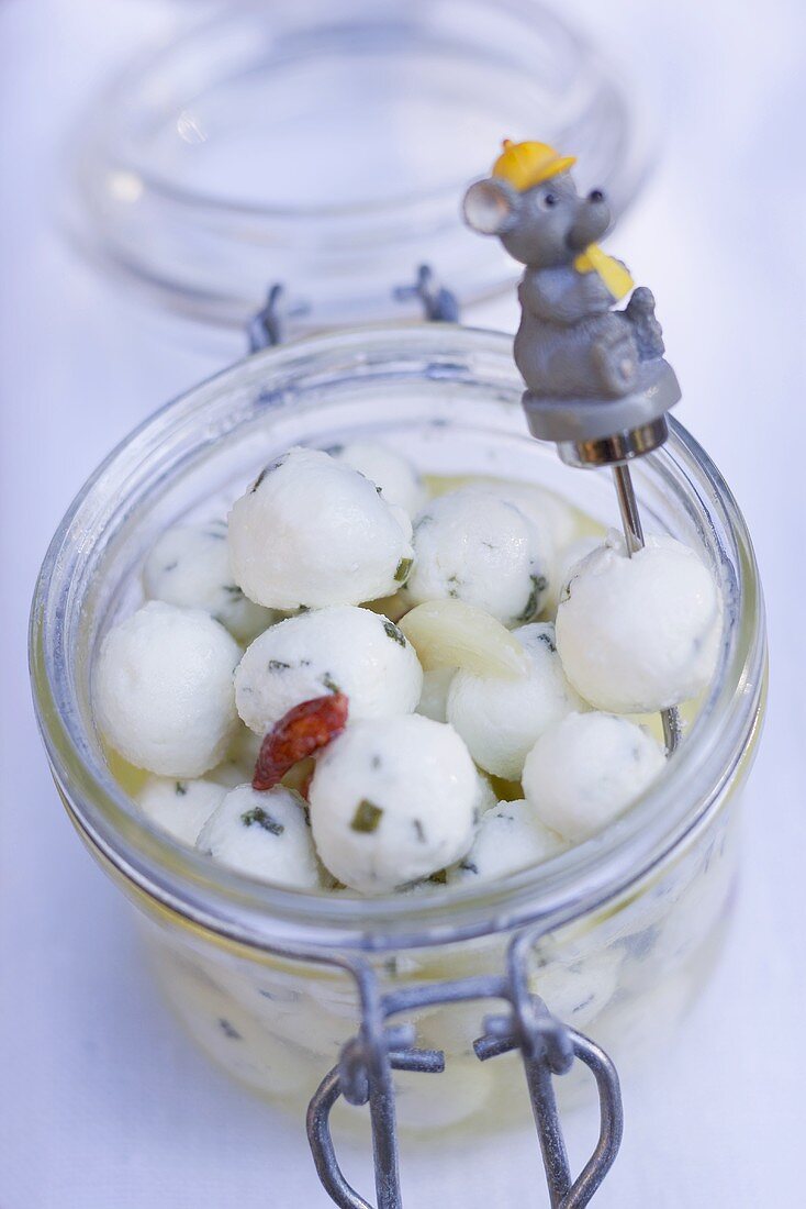 Marinated cheese balls in jar with mouse skewer