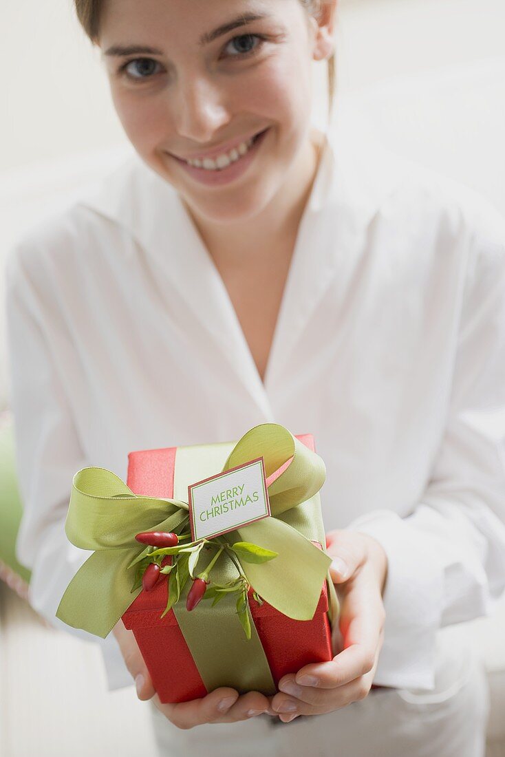 Young woman holding Christmas gift