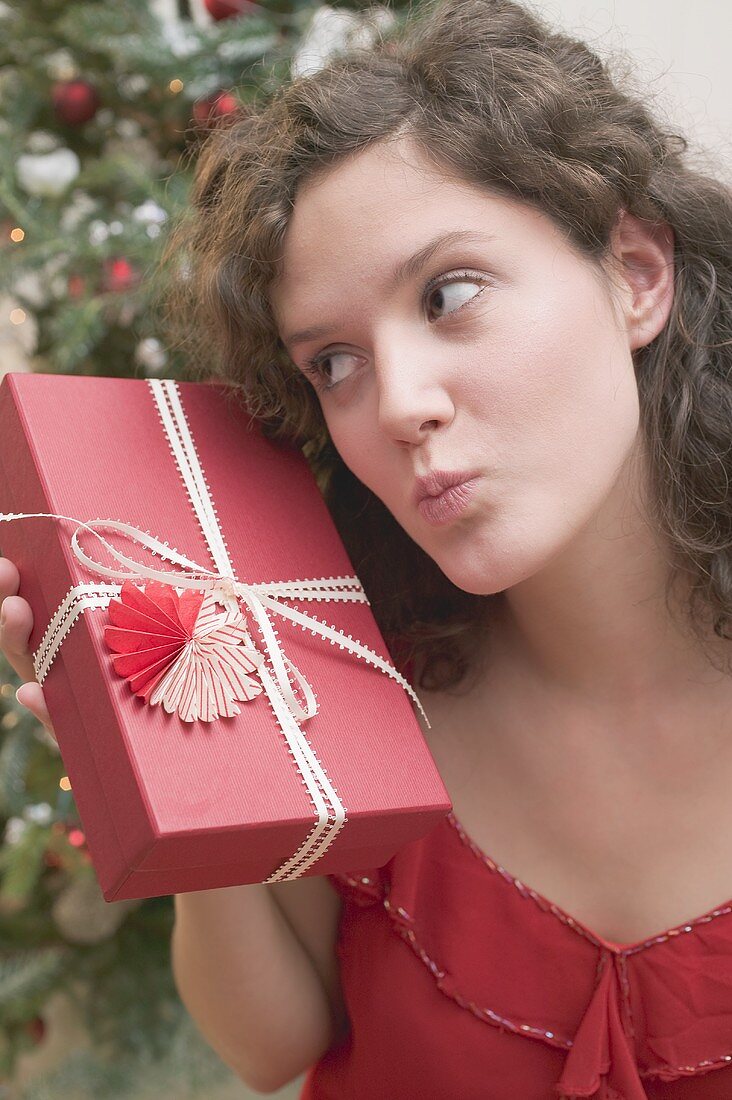 Woman looking quizzically at Christmas gift