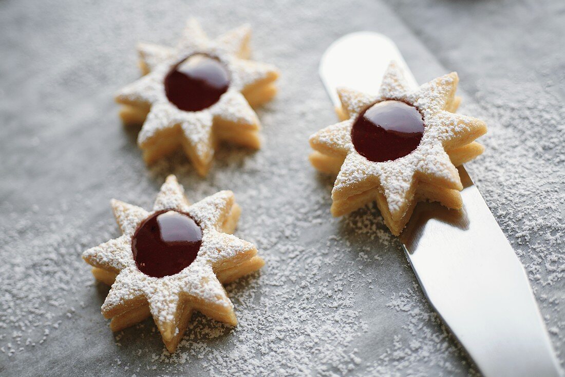 Three jam biscuits with icing sugar