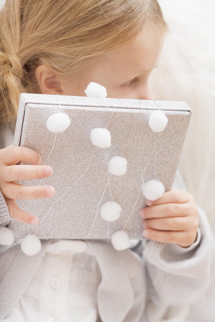 Small girl holding Christmas gift