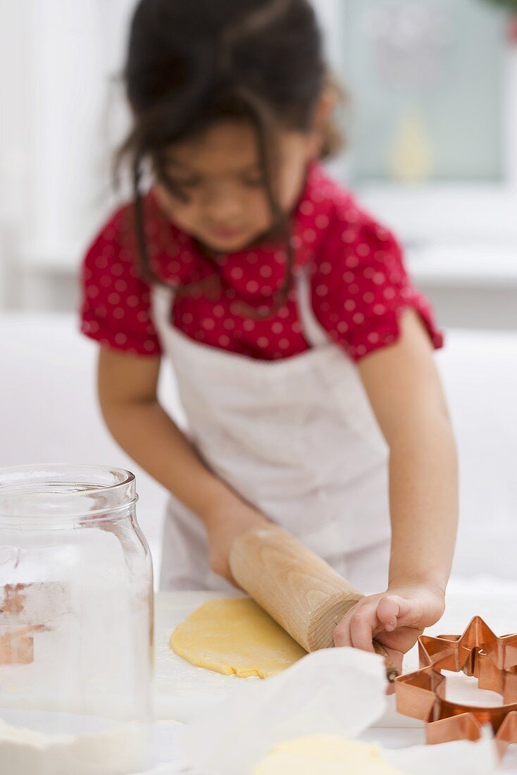 Child rolling out dough