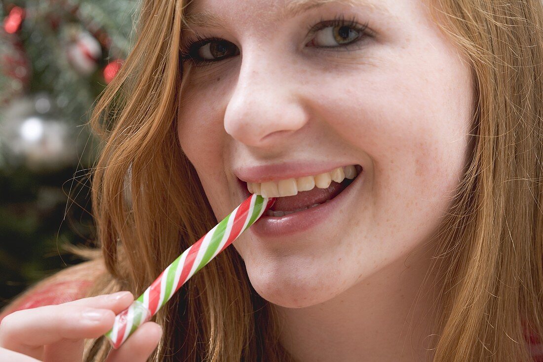 Woman eating candy cane
