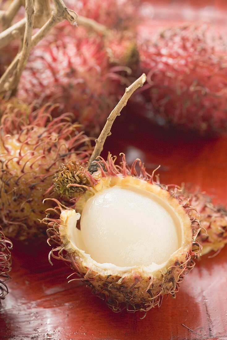 Several rambutans, one cut open