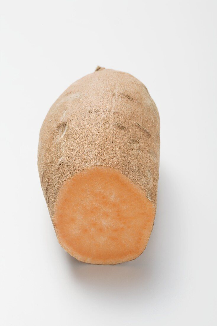 A sweet potato with a piece cut off
