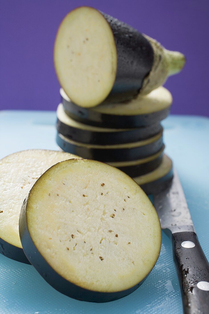 Aubergine slices on chopping board