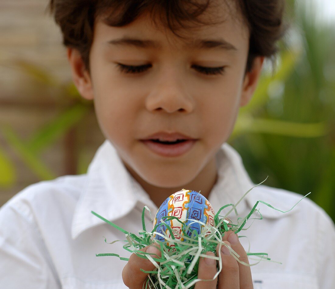 Boy holding an Easter egg in his hand