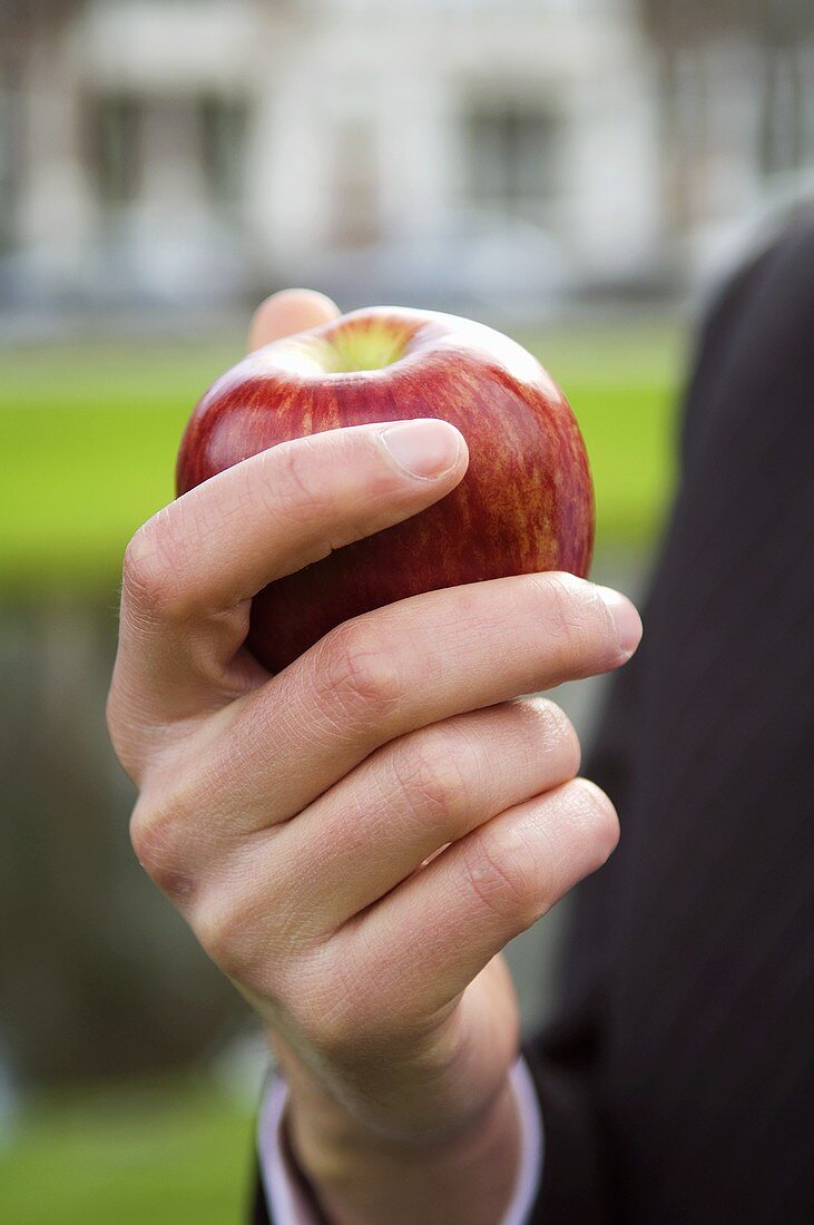 Hand holding an apple