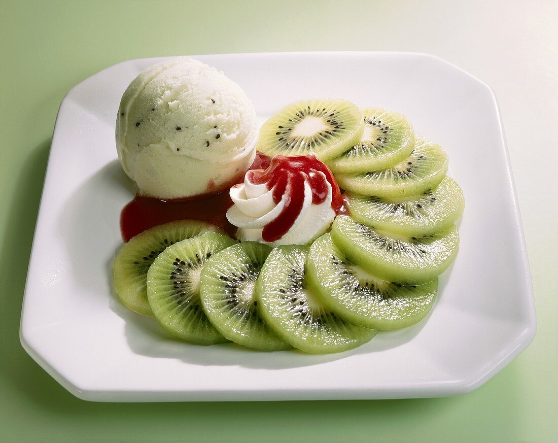 Kiwi ice cream, kiwi fruit slices, cream, strawberry sauce