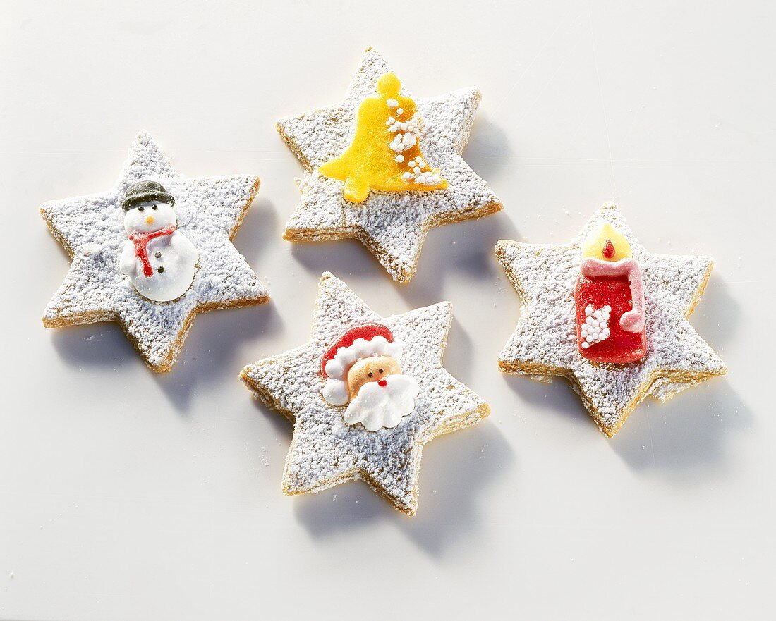 Star-shaped biscuits decorated with sugar figures