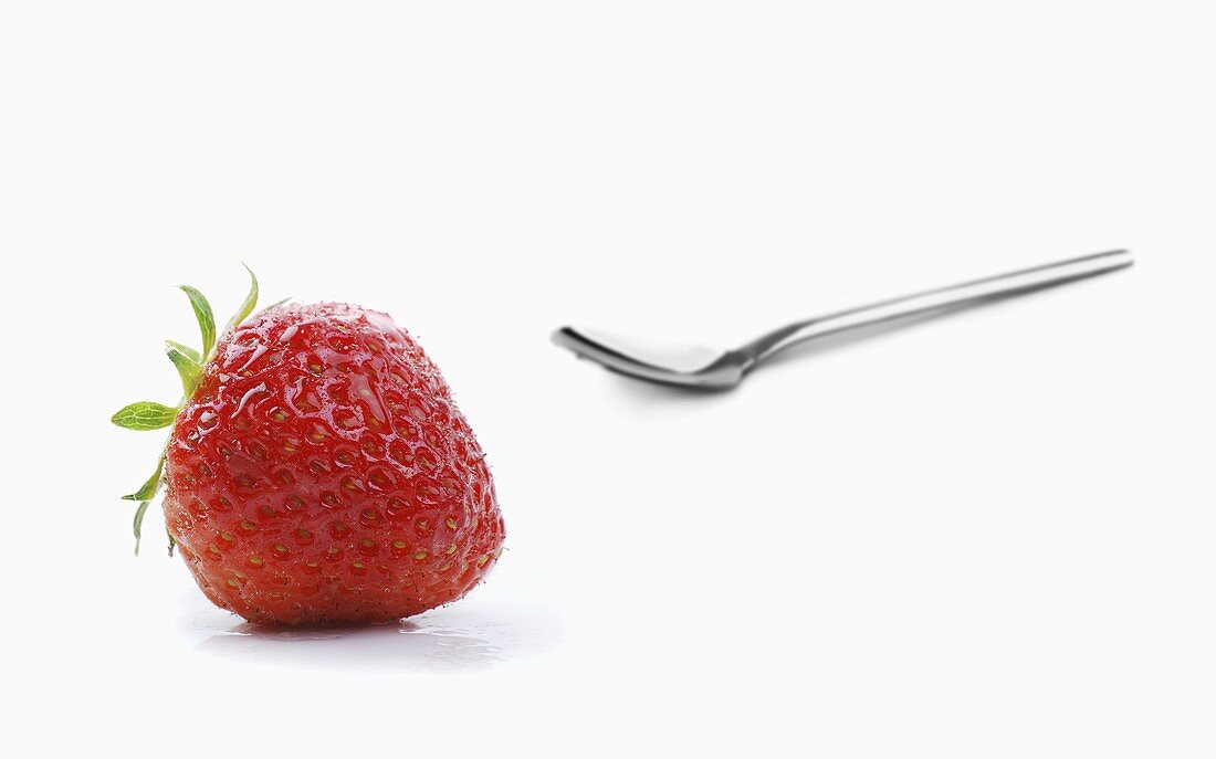 A strawberry and a spoon