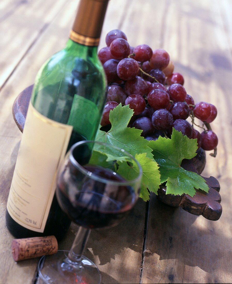 Still life with red wine and red wine grapes