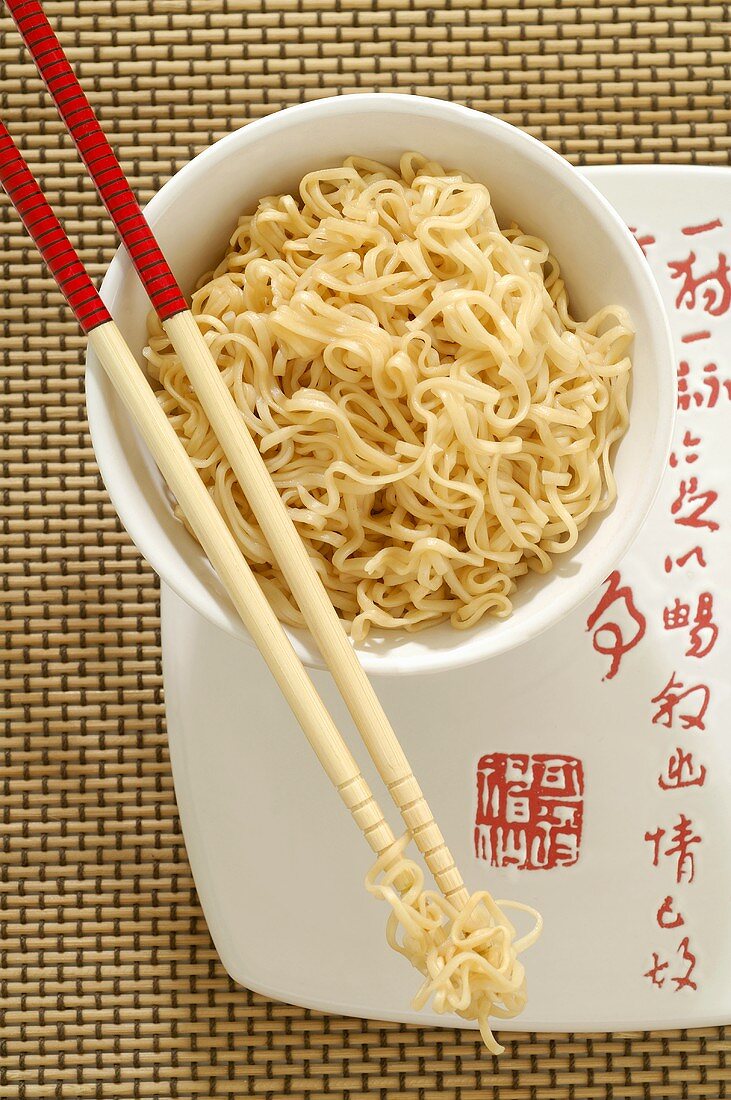 Asian noodle dish in a bowl with chopsticks