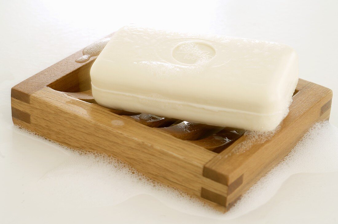 Yoghurt soap on wooden soap dish