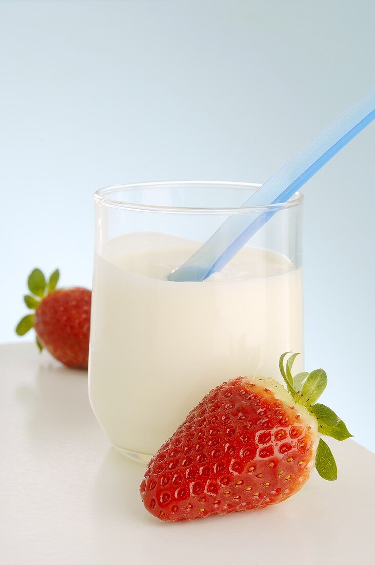 A glass of yoghurt and strawberries