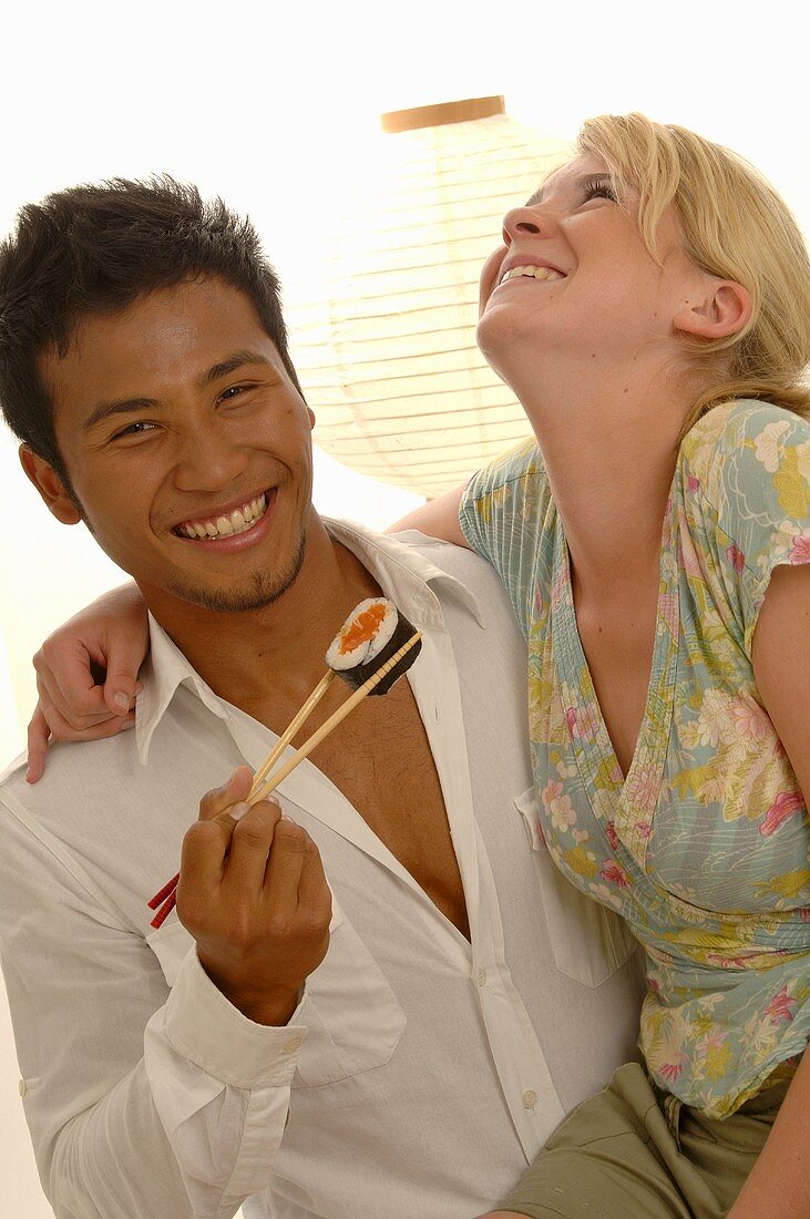 Young couple with sushi