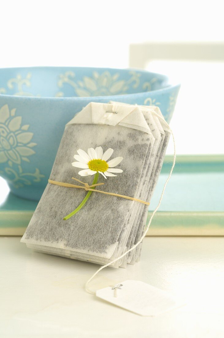 Tea bag with chamomile flower and tea bowl