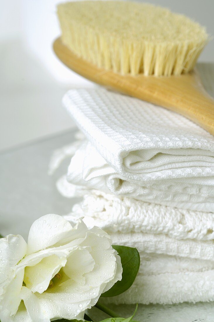 Towels and massage brush with lisianthus flowers