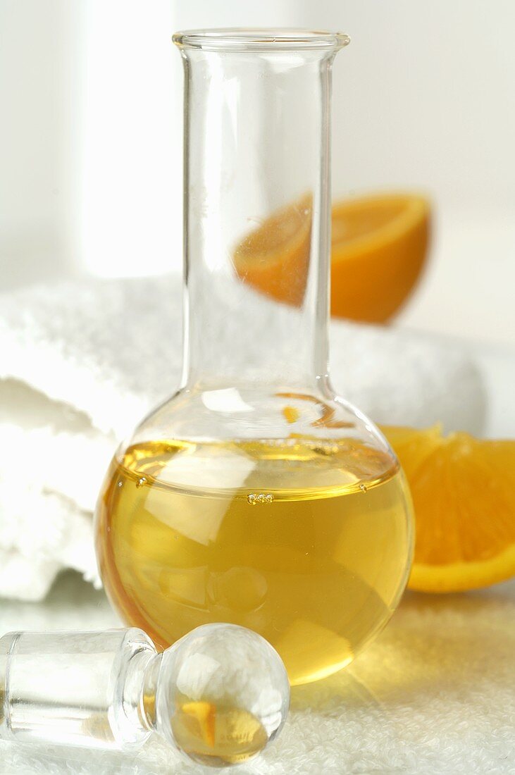 Orange oil, towels in background