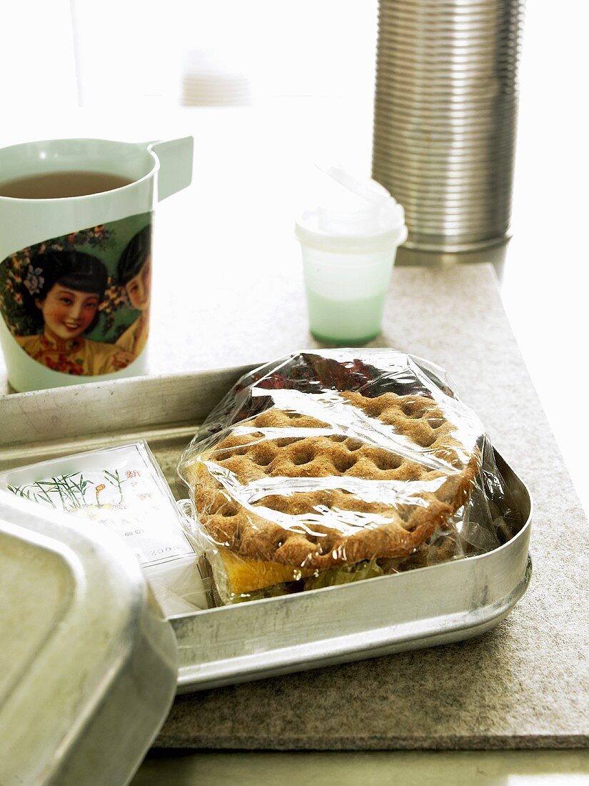 Lunch box containing crispbread sandwich, tea