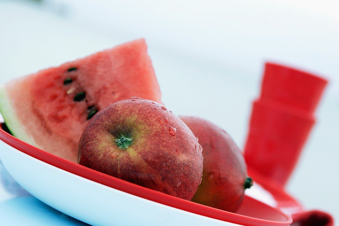 Watermelon and apples on plate